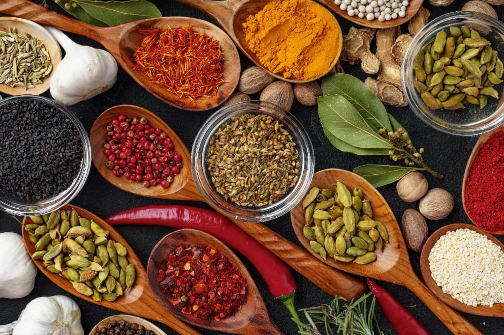 Assortment of premium spices and herbs in wooden spoons